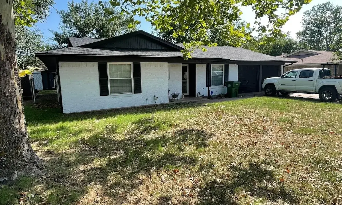 Professional roofing crew working on a residential roof in Derby